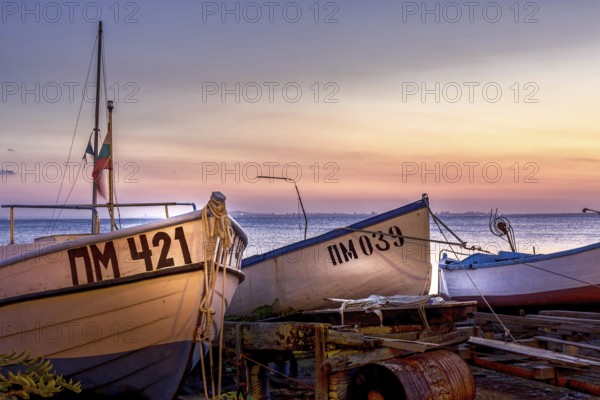 Pomorie, Bulgaria, September 15, 2020: Beachfront sea panorama with fishing boats in the town and seaside resort on Black sea, sunset view, Europe