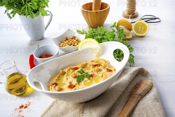 Hummus paste with lemon and chilli on a white background