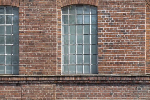 Three large mullioned windows in a uniform brick wall, Bottrop, North Rhine-Westphalia, Germany, Europe