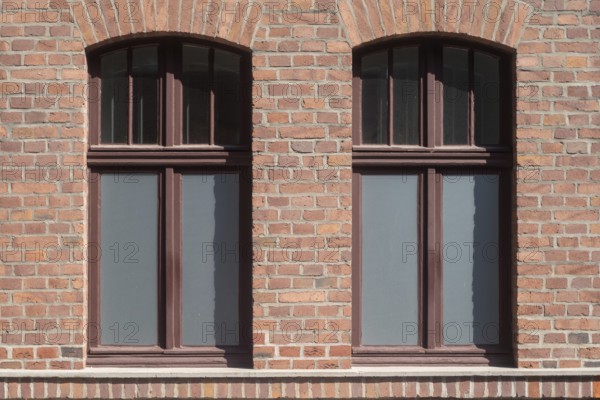 Two symmetrically arranged windows in a brick façade, Bottrop, North Rhine-Westphalia, Germany, Europe