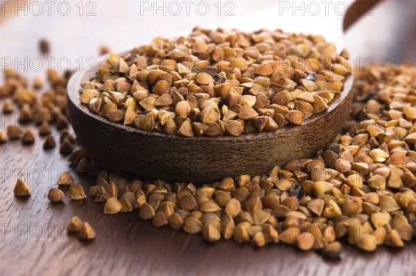 Buckwheat seeds on wooden spoon in closeup, lodz, poland