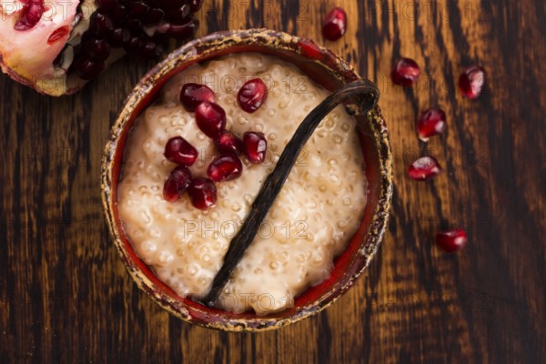 A bowl of tapioca pudding with vanilla and pomegranate