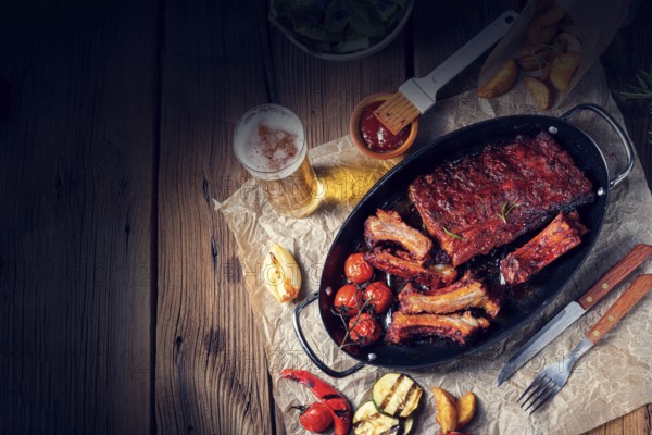 Grilled ribs in a spicy marinade with salad and vegetables