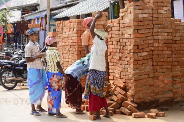Kanchipuram, Tamil Nadu, South India, India, Asia, Group of labourers stacking bricks on the street, Asia