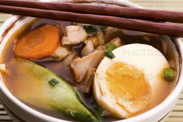 Ramen egg noodle soup dish with salmon fish