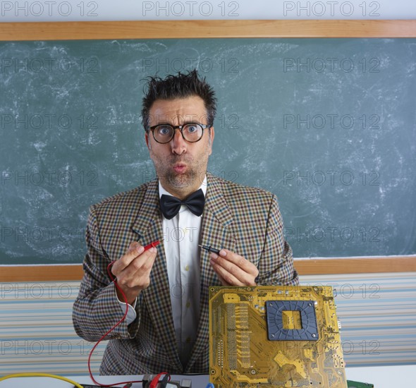 Nerd electronics technician retro teacher silly expression working in pcb