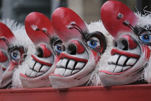Clown masks with large teeth and blue eye accent, cheerful and scary impression
