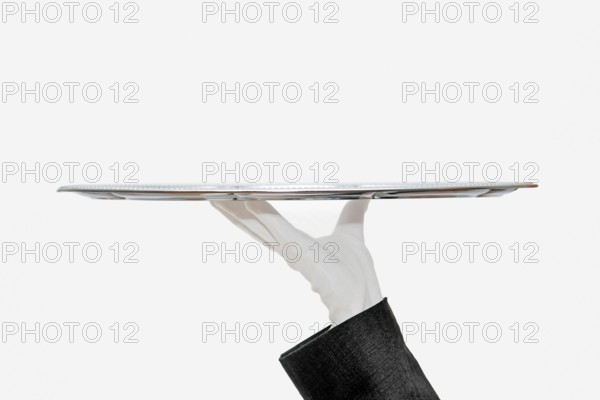 Waiter with white hemp shoes carries a silver tray
