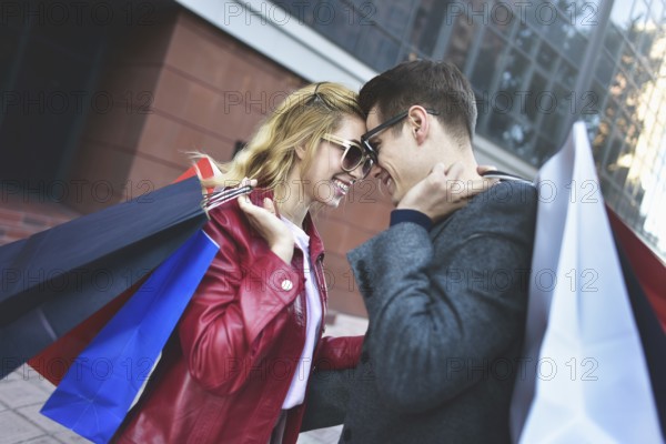 Portrait of a couple with shopping bags in the city.People, sale, love and happiness concept