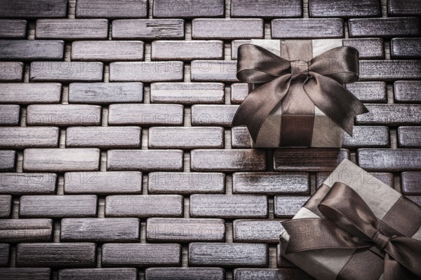 Presents wrapped with brown ribbons on wooden mat holidays concept