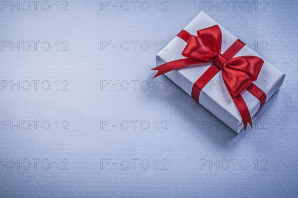 Present with ribbon on blue background holidays concept