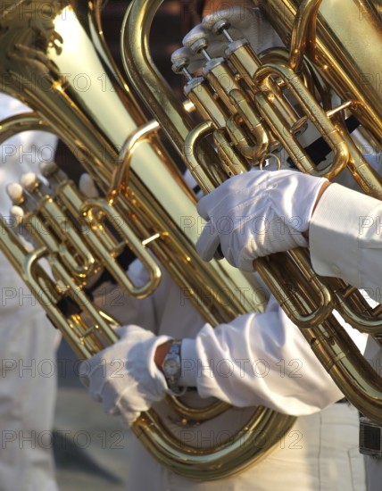 Partial view of two tubas that are part of a brass band