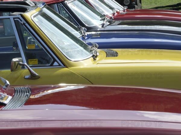 Hebden Bridge, West Yorkshire, England, August 4 2018: Close up of the bonnets and windscreens of a row of vintage triumph stag sports cars at hebden bridge vintage weekend public vehicle show