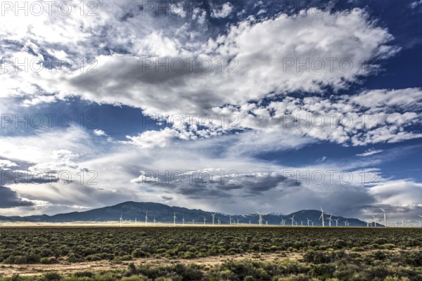 Wind turbines and wild thunder and rain clouds over the Great Basin Highway US 93, between Ely and Baker, Nevada, USA, North America