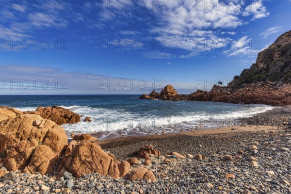 Coastal landscape with red rocks and surf in blue sky and sunshine, Spiaggia di Cala E'Luas, Ogliastra, Sardinia, Italy, Europe