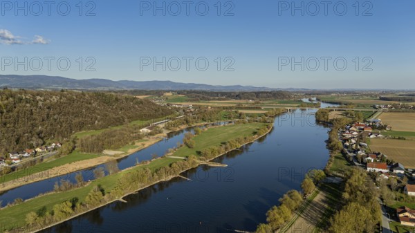 River (Danube) running through the landscape with neighbouring meadows and hills, under a blue sky, Bogen, Lower Bavaria, drone shot