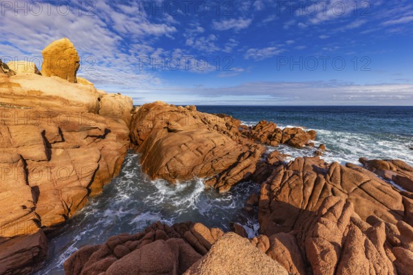 Coastal landscape with red rocks and surf in blue sky and sunshine, Spiaggia di Cala E'Luas, Ogliastra, Sardinia, Italy, Europe