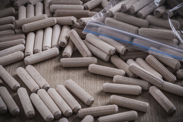 Composition of wooden dowels on wood board construction concept