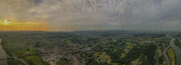 Aerial view of a cityscape with river, fields and forests at sunset under a cloudy sky, Bogen, Lower Bavaria