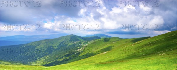 Beautiful blue sky and meadows in Carpathian mountains. Panoramic view