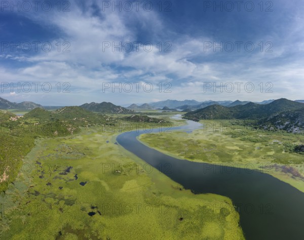 Aerial view of Rijeka Crnojevica, beautiful river between mountains flowing into Skadar Lake, Montenegro, Europe