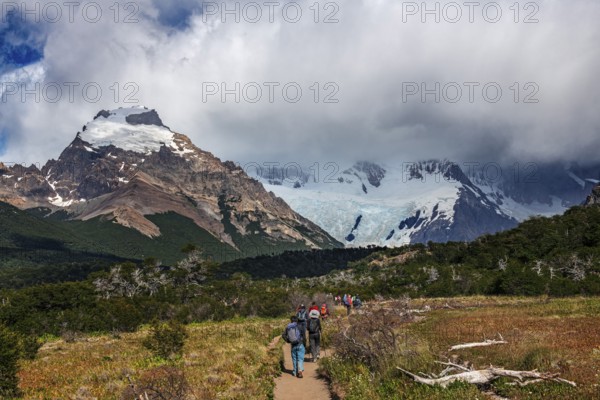 Trekkers at Cascada Martin with a view of the Fitzroy Massif, El Chaltén, Los Glaciares National Park, Santa Cruz, Patagonia, Argentina, South America