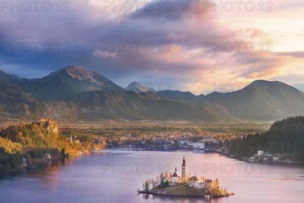 Colorful sunrise over the Bled lake, its surrounding hills, its island and the Karawanks mountains in the background, situated in Slovenia