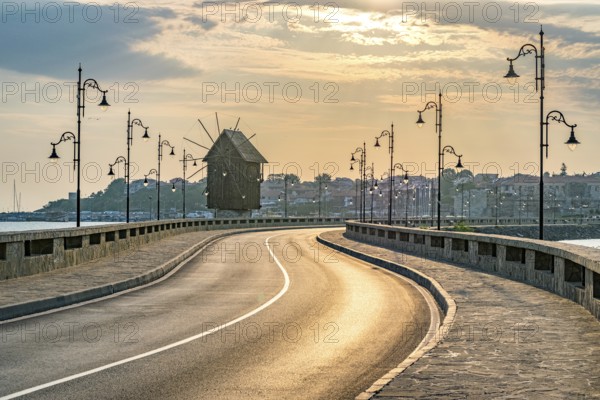 The wooden windmill on the isthmus at sunrise in Nessebar ancient city on the Bulgarian Black Sea Coast. Nesebar or Nesebr is a UNESCO World Heritage Site. The windmill in Nessebar, Bulgaria, Europe