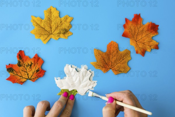 Maple leaf with painted face as decoration for autumn Halloween holiday celebration. Halloween party in October. Holiday Diy preparation. Step by Step Mysterious Jack head lantern