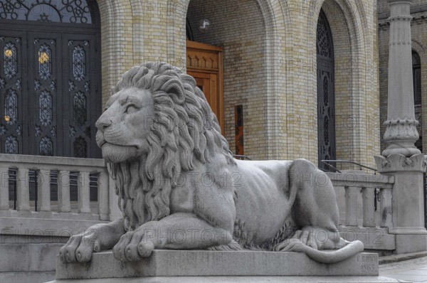 Magnificent stone lion statue in front of a historic building, oslo, norway