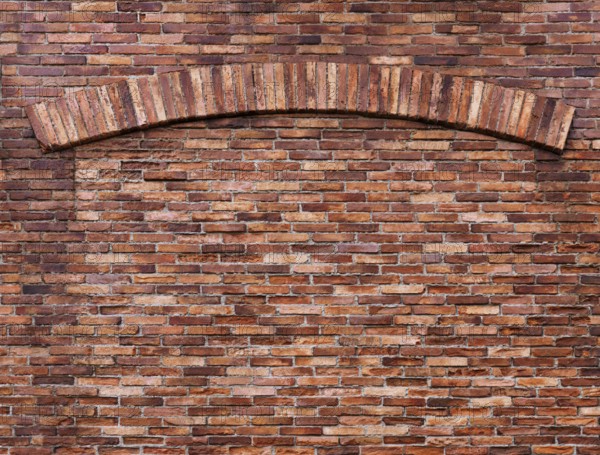 Texture of old red brick wall with an arch, grungy background