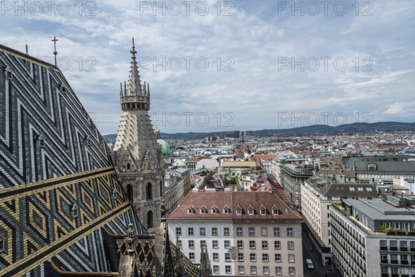 Vienna, Austria, August 16, 2017: Panoramic view of Vienna from the roof of Cathedral of St Stephen. Built in romanesque and gothic style, with its multi-coloured tile roof is a city's symbols, Europe