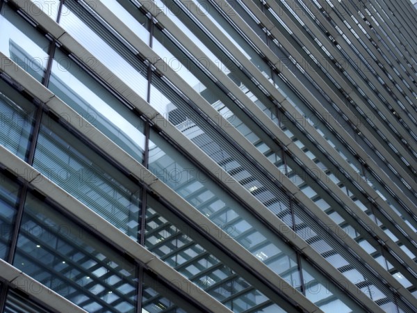 A full frame modern office architecture abstract with geometric shapes and buildings reflected in blue glass windows