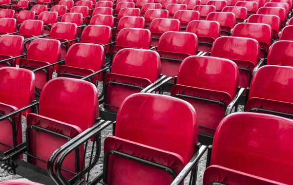 Empty plastic red chairs In outdoor theater in sunny day