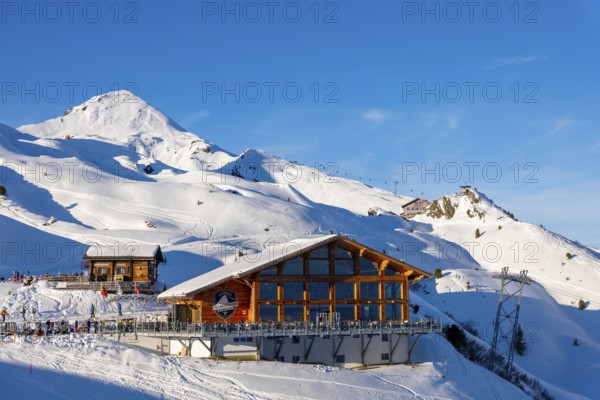 Ski Slope with Overhead Cable Car and Restaurant at 2000 Meters High Up and Mountain Peak in a Sunny Winter Day with Blue Sky in Kleine Scheidegg, Bernese Oberland, Grindelwald, Canton Bern, Switzerland, Europe