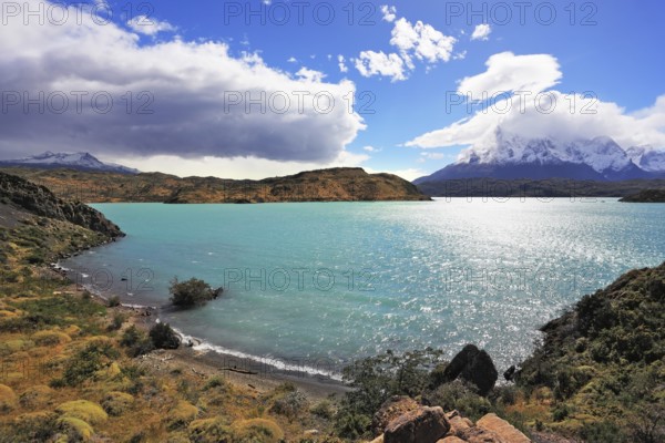 Magic turquoise lake Pehoe national park Torres del Paine, Chile. Majestic rocks Los Kuernos on the bank of the lake are covered with glaciers