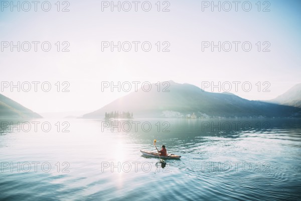 Kayaks in the lake. Tourists kayaking on the Bay of Kotor, near the town of Perast in Montenegro. Aerial Photo drone
