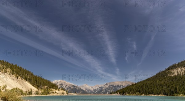 The turquoise waters of Whitemans Pond at an elevation of 1876m and surrounded by the east end of Mount Rundle, Ha Ling Peak and Mount Lawrence just outside of Canmore, Alberta, Canada, North America