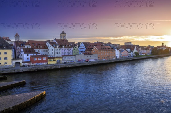 Historic cityscape of Regensburg at the river Daube during sunset