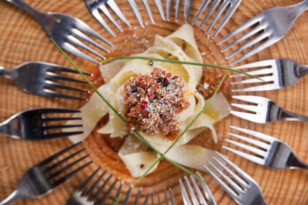 Presentation first dish of pappardelle with meat sauce and tomato