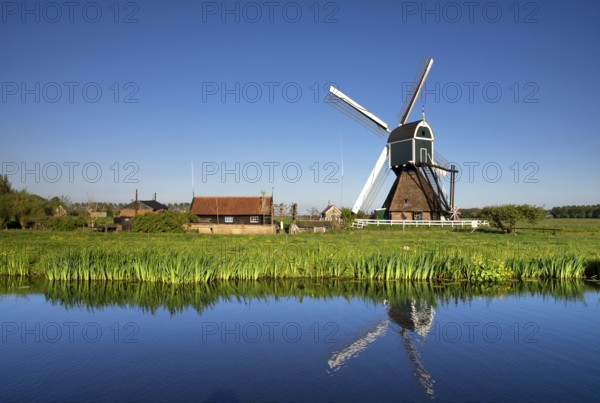 Windmill the Wingerdse Molen close to the Dutch village Bleskensgraaf seen on a clear and crisp day in spring