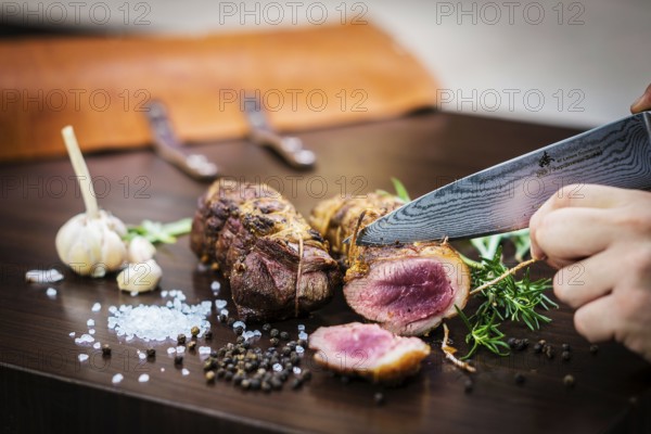 Serving carving roast pork meat roll meal in rustic style with seasonings