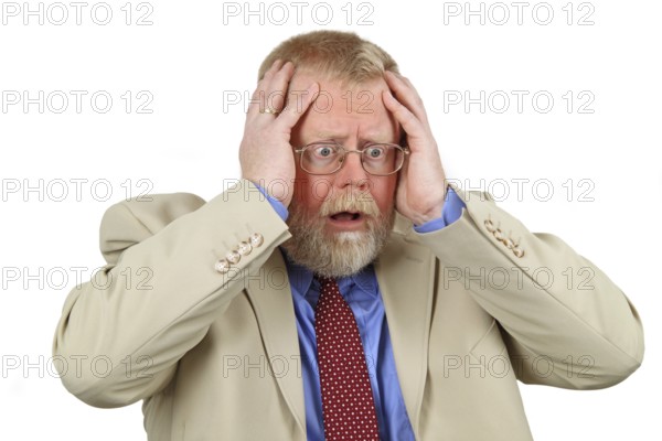 Desperate man holding both hands to his head. White background