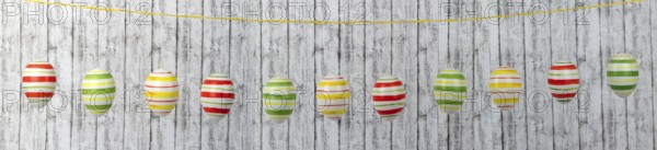 Colourful Easter eggs on a string in a row