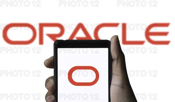 ORACLE logo displayed on smartphone screen. ORACLE is a multinational computer technology corporation