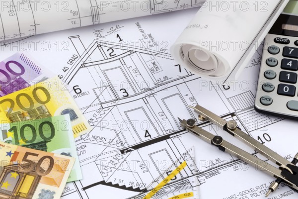 An architect's construction plan with a pocket calculator and euro money. Symbolic photo for financing and planning a new house. Austria