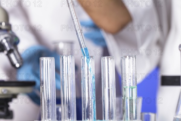 The blue drop from pipette in laboratory tubes