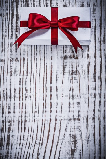 Copyspace of packed giftbox on vintage wood board holidays concept