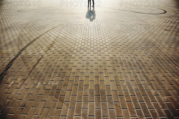 Lovely couple on the square with stone floor background.