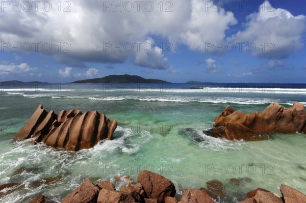 Rocks in the water at Anse Banane, with Felicite Island behind, La Digue Island, Seychelles, Indian Ocean, Africa